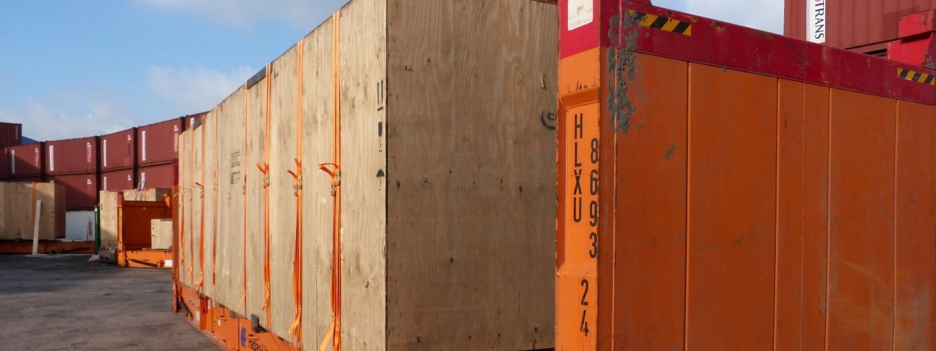 Oransje containere utendørs, lastsikring. Foto