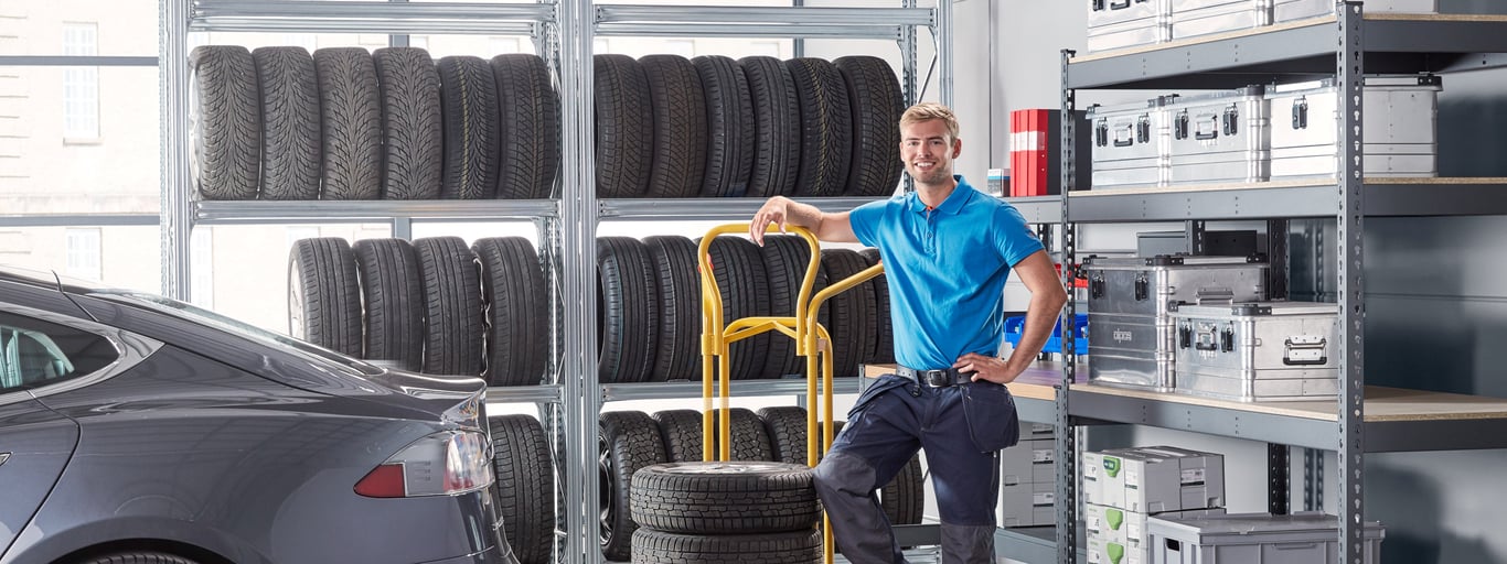 Man som står i en bilverkstad med produkter från Cowab